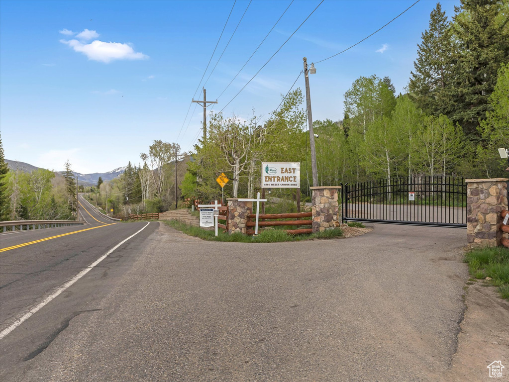View of asphalt road with a gate and a mountain view