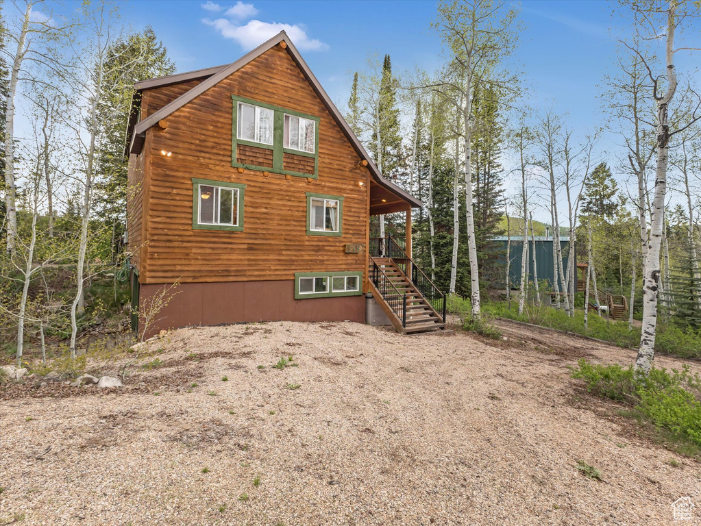 View of side of property featuring stairs