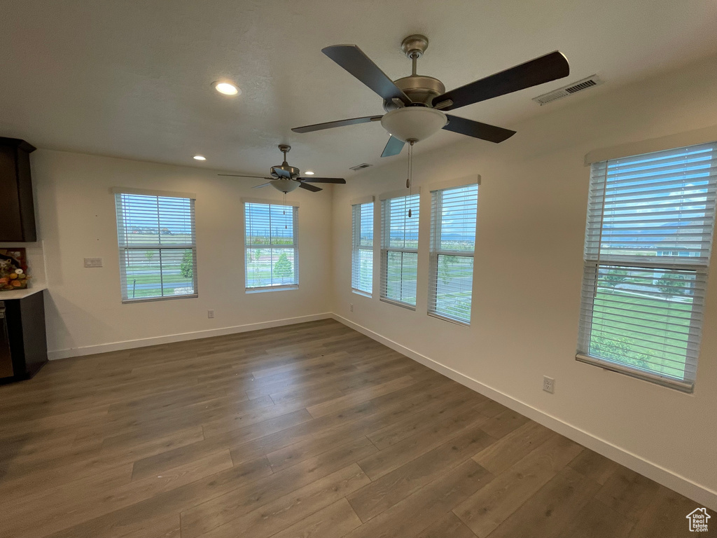 Spare room with dark wood finished floors, baseboards, a ceiling fan, and recessed lighting
