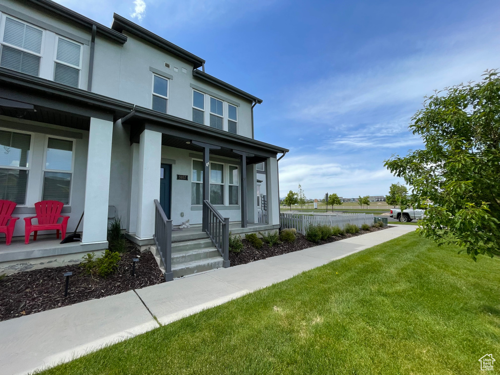 View of front of home featuring a porch and stucco siding