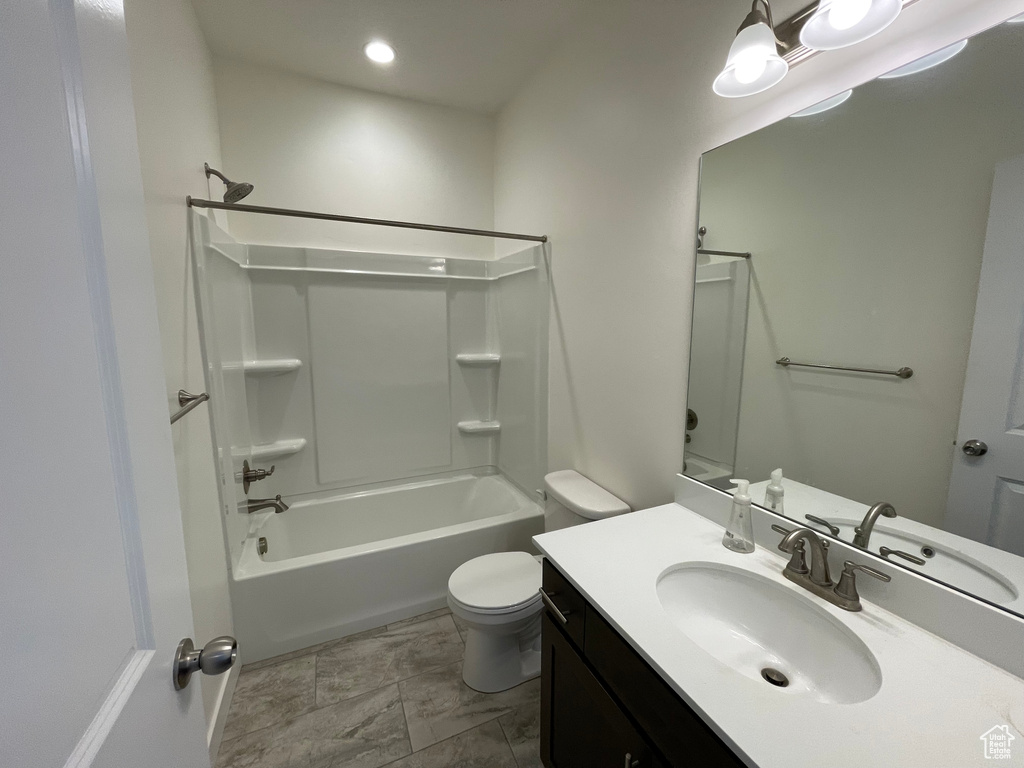 Bathroom featuring vanity, toilet, shower / bathtub combination, and recessed lighting