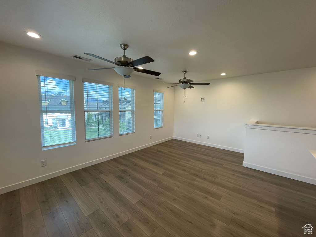 Spare room featuring a ceiling fan, baseboards, recessed lighting, and dark wood-style flooring