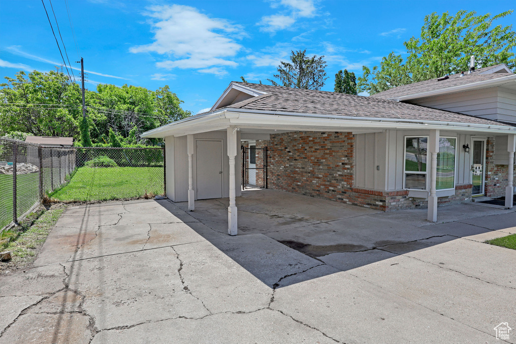 View of patio featuring a carport and concrete driveway