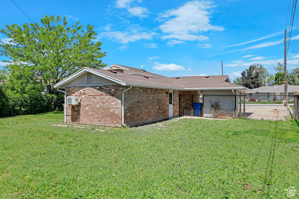 Back of house featuring brick siding
