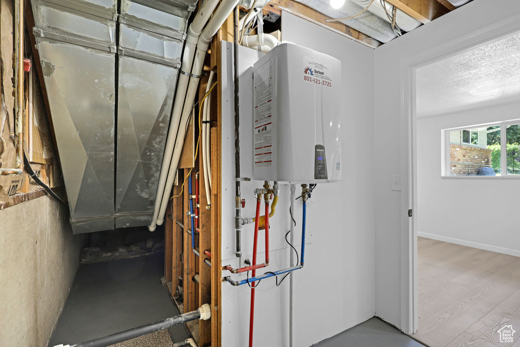 Utility room featuring water heater