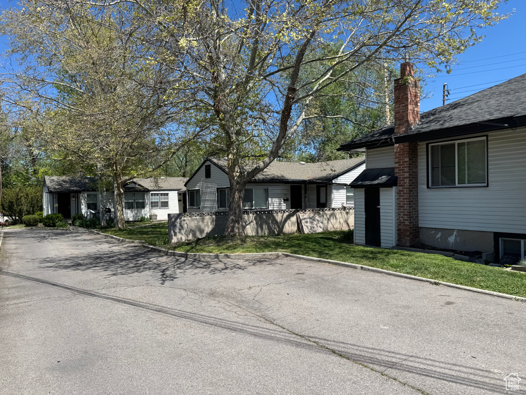 View of front of property with a chimney and a front lawn