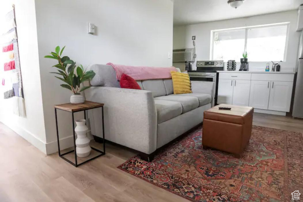 Living room featuring light wood-type flooring and baseboards