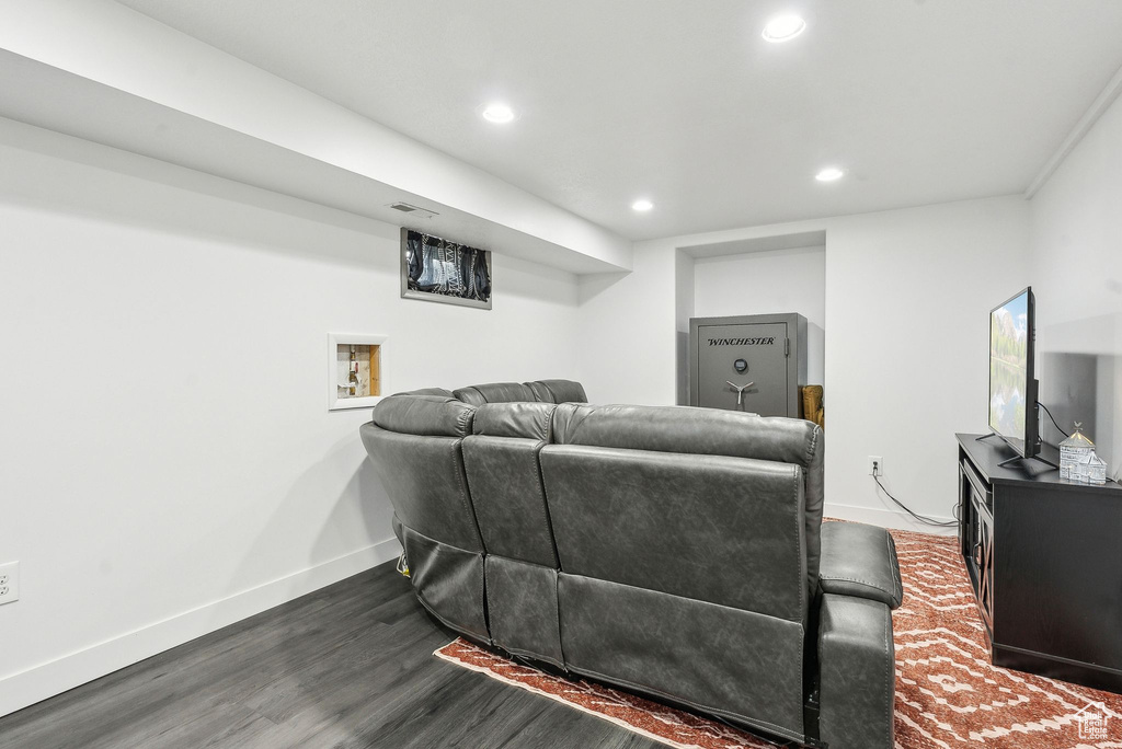 Living area with recessed lighting, dark wood finished floors, and baseboards