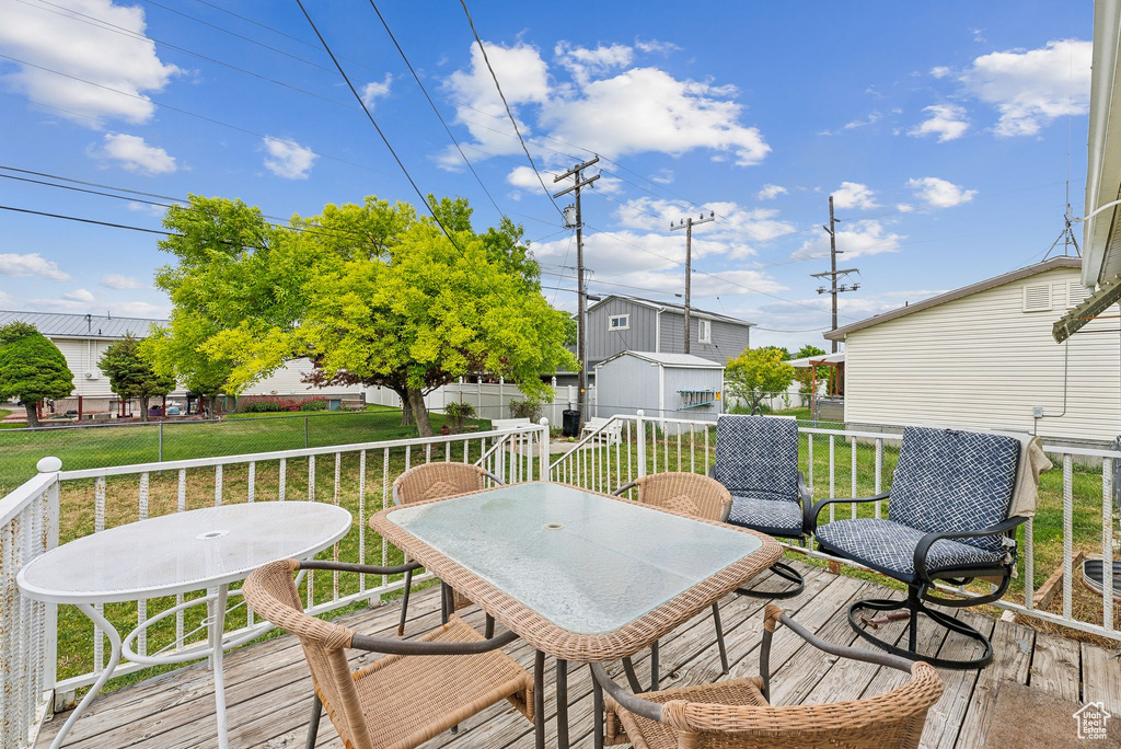 Wooden terrace featuring outdoor dining area