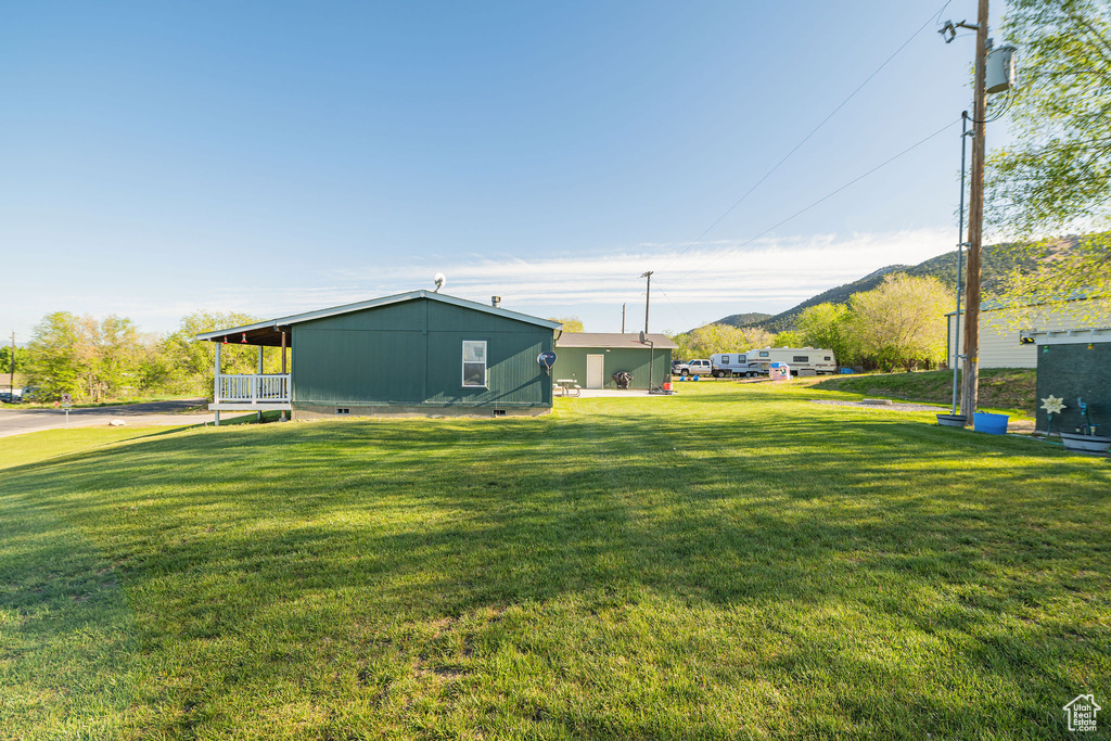 View of grassy yard with a mountain view