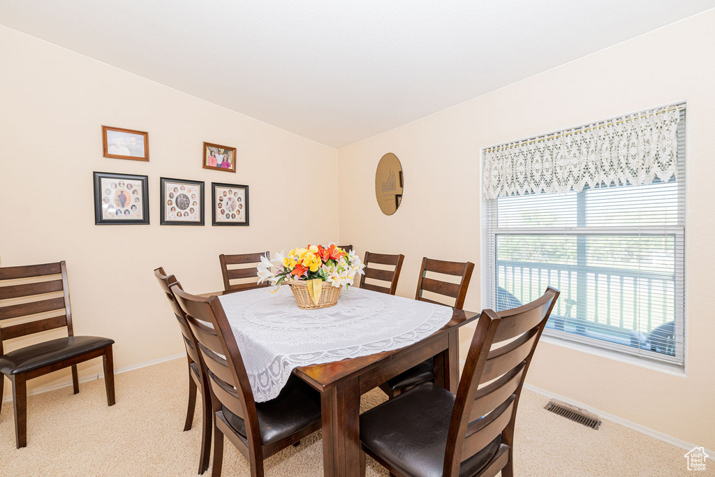 Dining room with light carpet and baseboards
