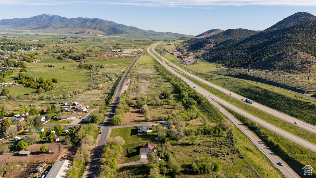 Aerial view of property's location featuring a mountain backdrop and rural landscape
