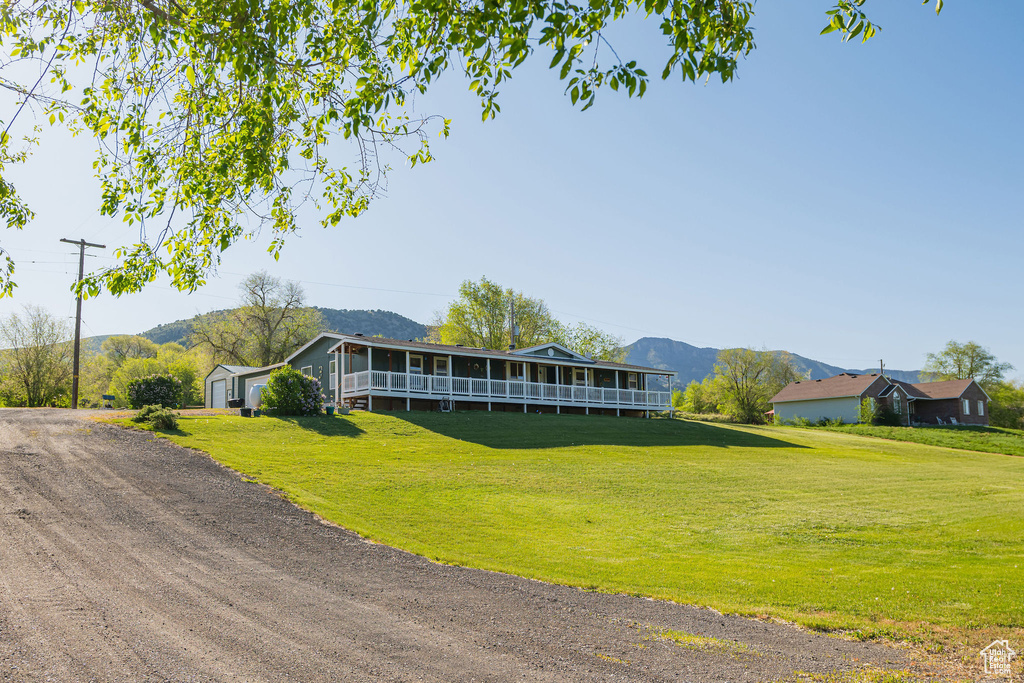 View of building exterior with a mountain view and a garage