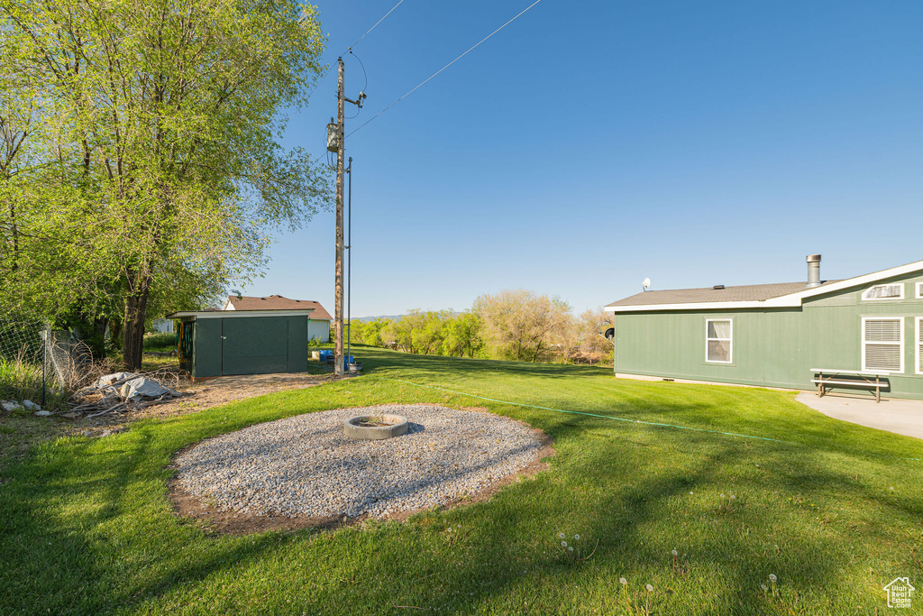 View of grassy yard with an outdoor structure