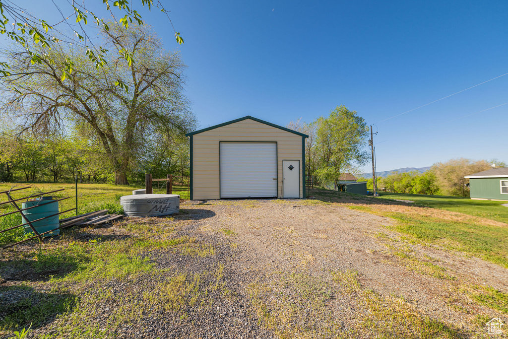 Detached garage featuring gravel driveway and a mountain view