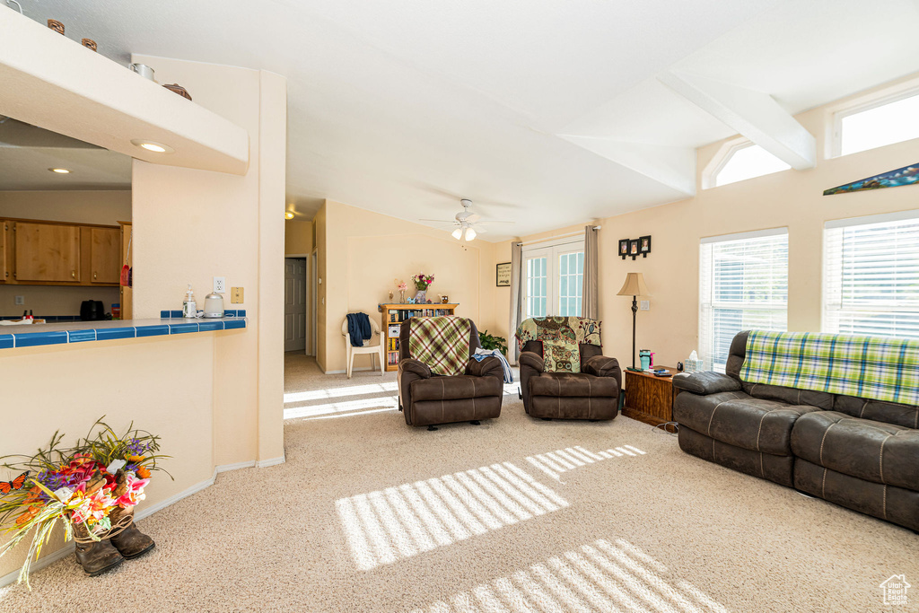 Living room featuring light carpet, vaulted ceiling, a ceiling fan, baseboards, and recessed lighting
