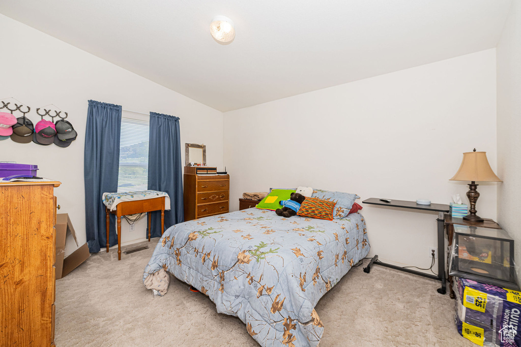 Bedroom featuring carpet floors and lofted ceiling
