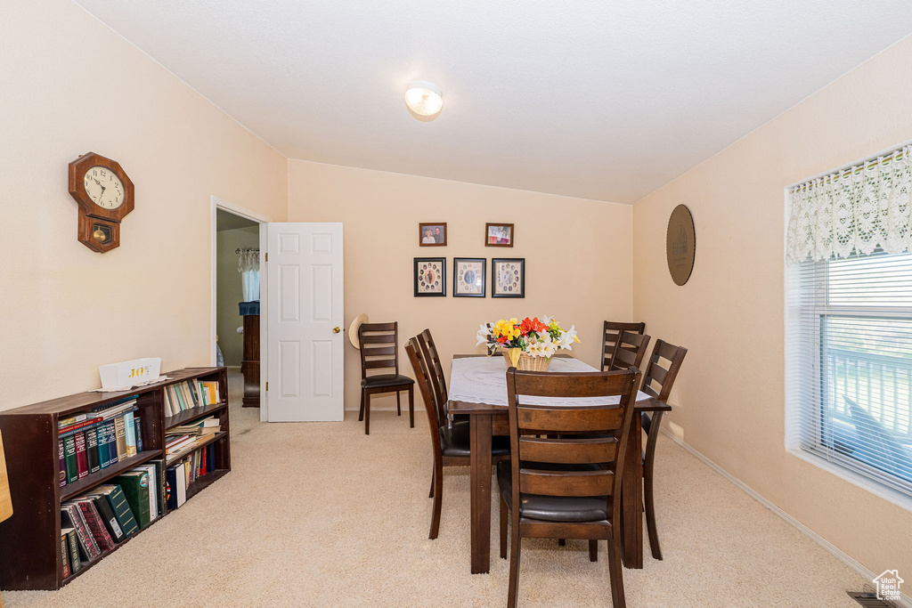 Dining room featuring light carpet