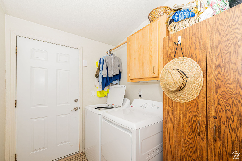 Washroom with cabinet space and independent washer and dryer