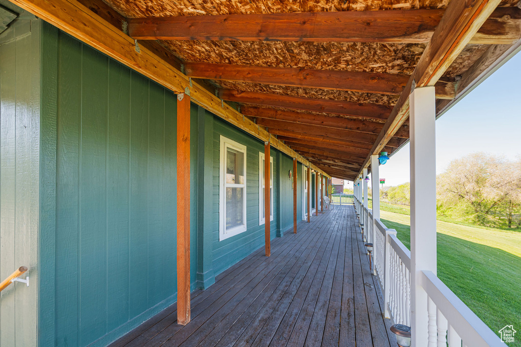 Wooden terrace featuring a lawn