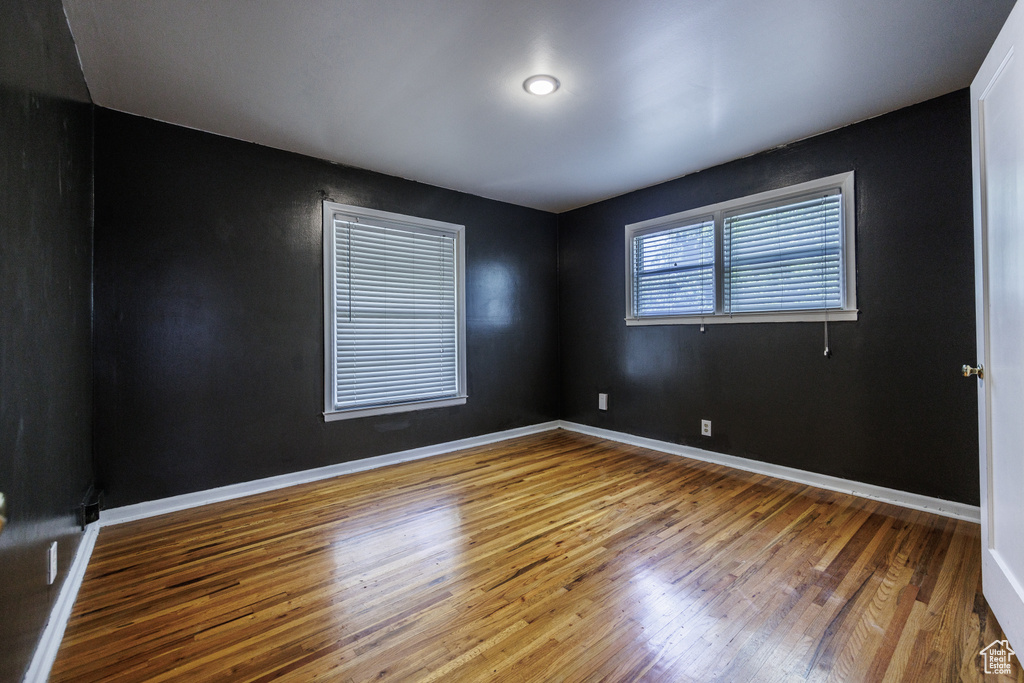 Empty room with wood finished floors and baseboards