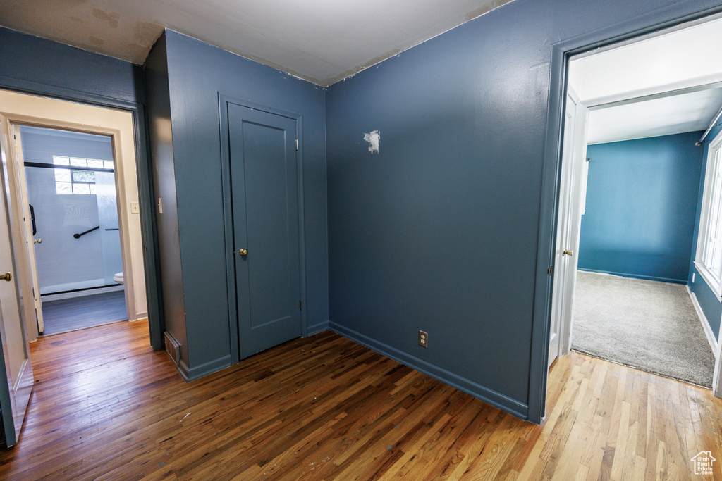 Corridor featuring wood finished floors and baseboards