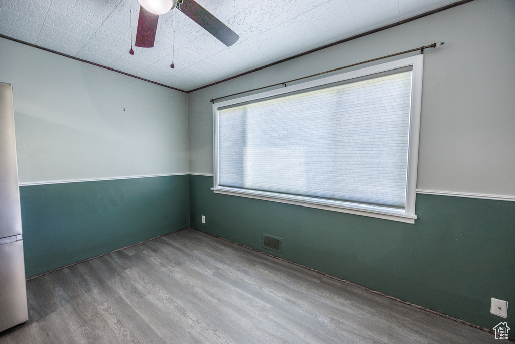 Empty room with ceiling fan and wood finished floors