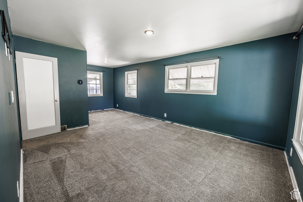 Empty room with carpet and baseboards