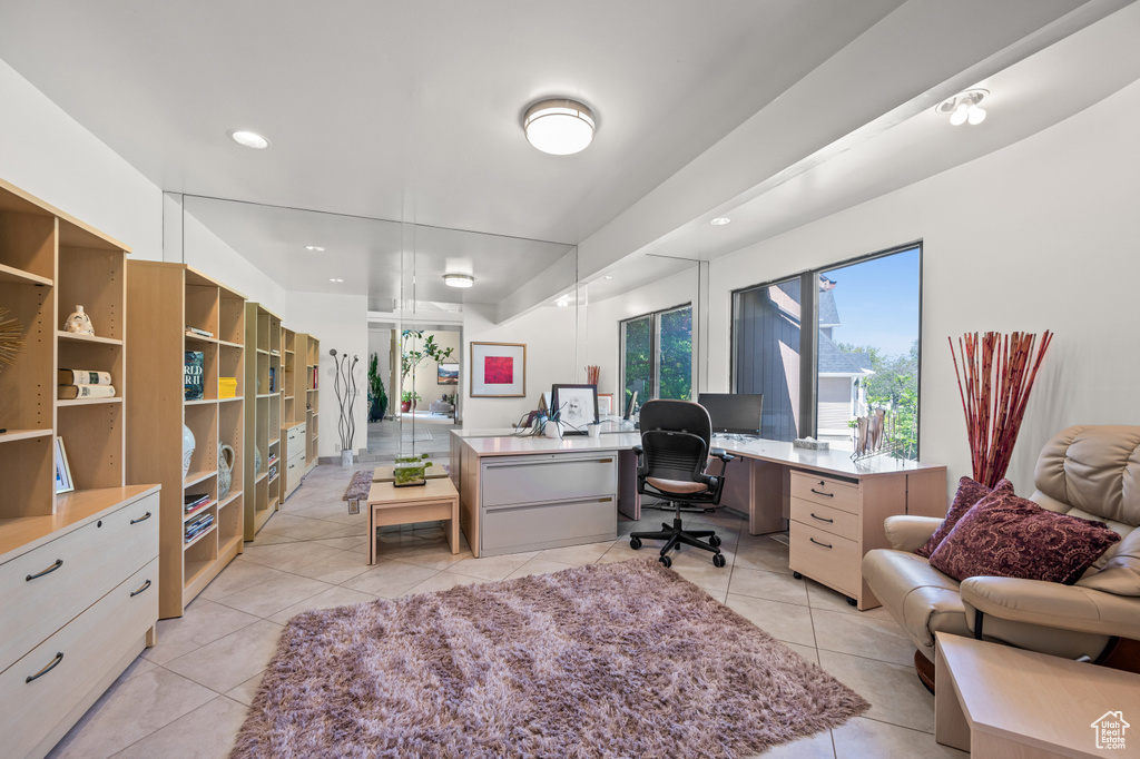 Office area with light tile patterned floors and recessed lighting