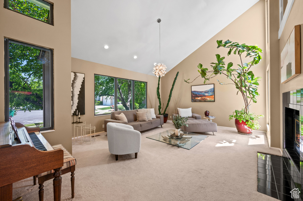 Living room with high vaulted ceiling, carpet, a tile fireplace, baseboards, and recessed lighting
