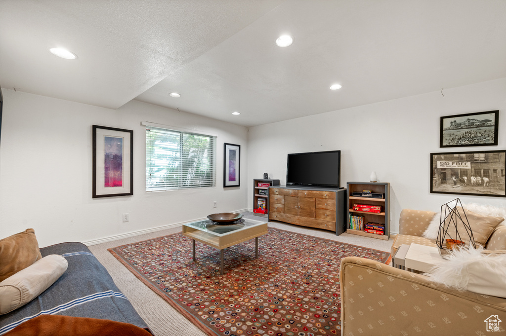 Living room with carpet flooring, baseboards, and recessed lighting