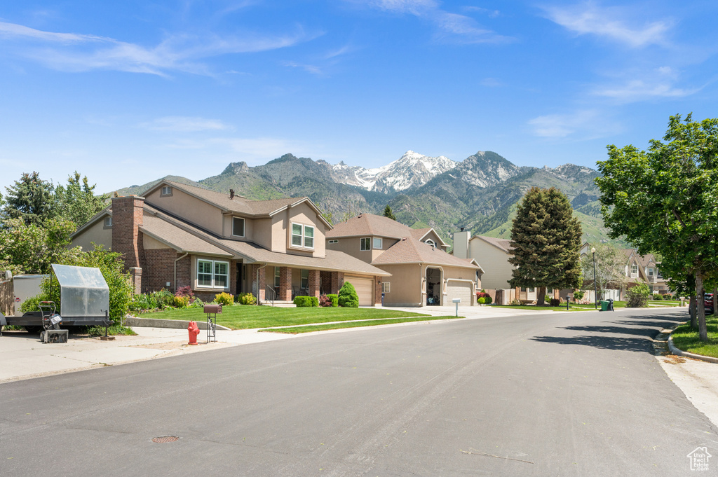 View of asphalt street featuring a mountain view and a residential view