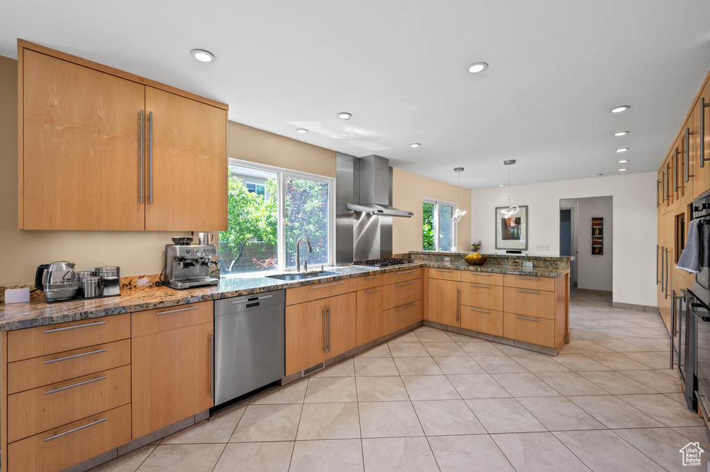 Kitchen with stainless steel appliances, a sink, a peninsula, plenty of natural light, and recessed lighting