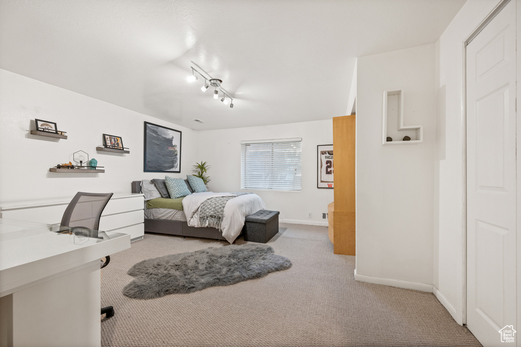 Bedroom featuring carpet floors and baseboards