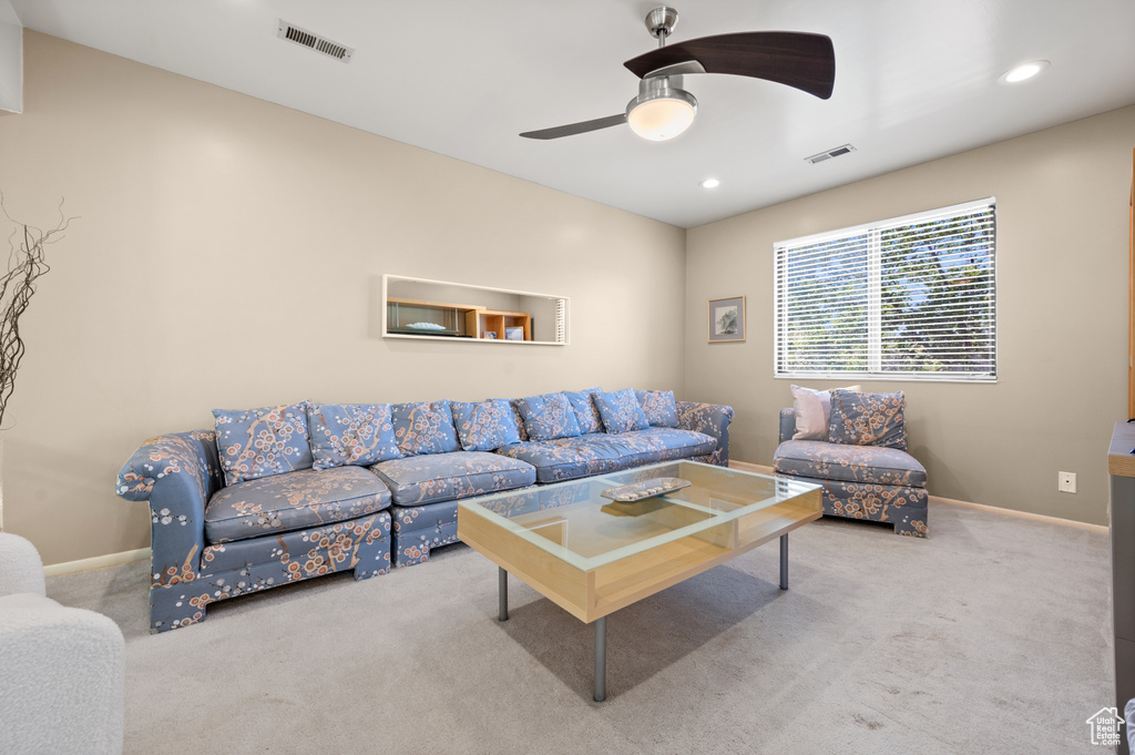 Living area with carpet flooring, ceiling fan, recessed lighting, and baseboards