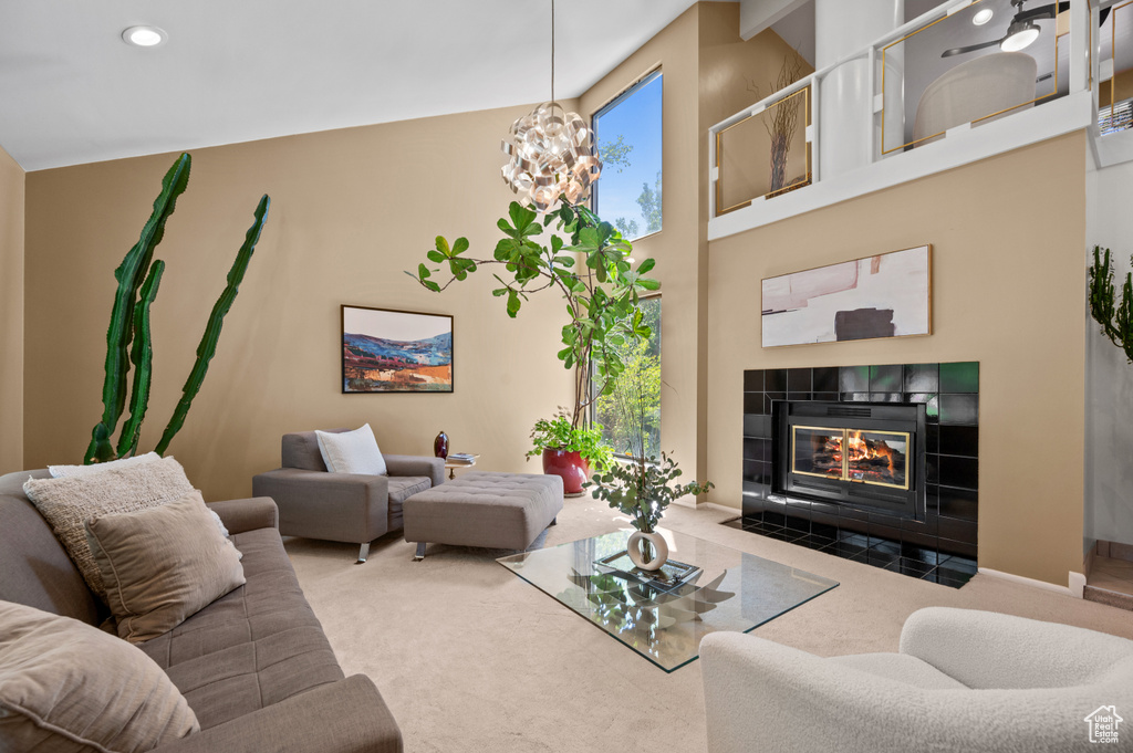 Living area with carpet floors, a tiled fireplace, a chandelier, recessed lighting, and baseboards
