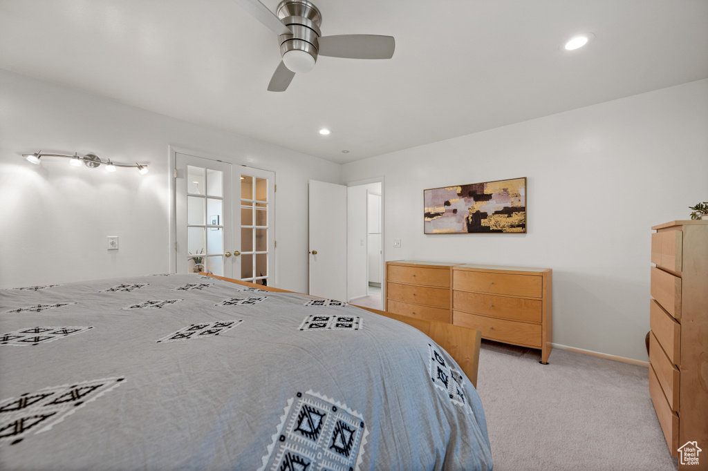 Bedroom with light colored carpet, french doors, recessed lighting, a ceiling fan, and baseboards