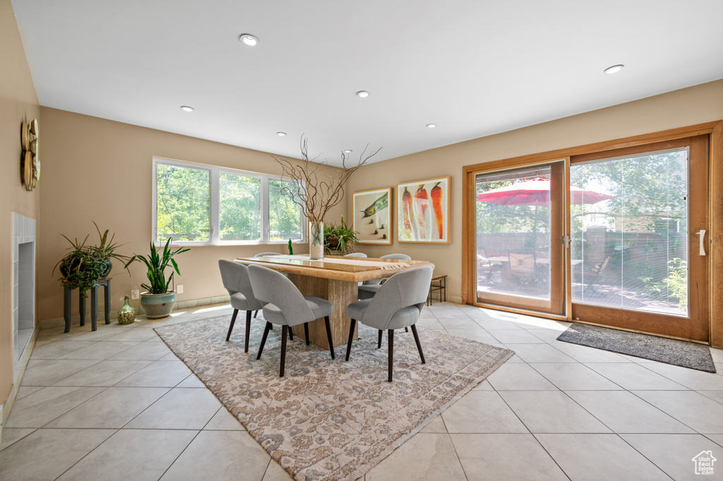 Dining area with light tile patterned floors and recessed lighting
