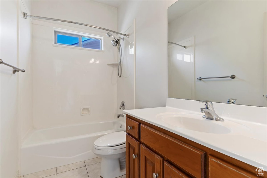 Full bath featuring shower / tub combination, toilet, vanity, and tile patterned floors