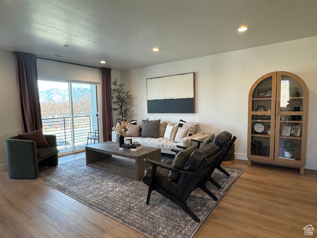 Living area featuring wood finished floors, recessed lighting, and baseboards