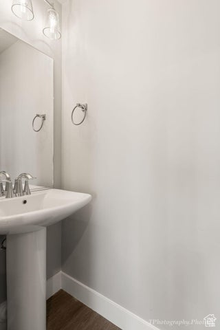 Bathroom featuring baseboards and wood finished floors