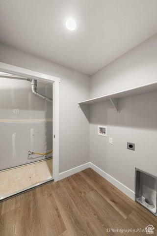 Laundry area featuring hookup for a washing machine, baseboards, wood finished floors, and electric dryer hookup