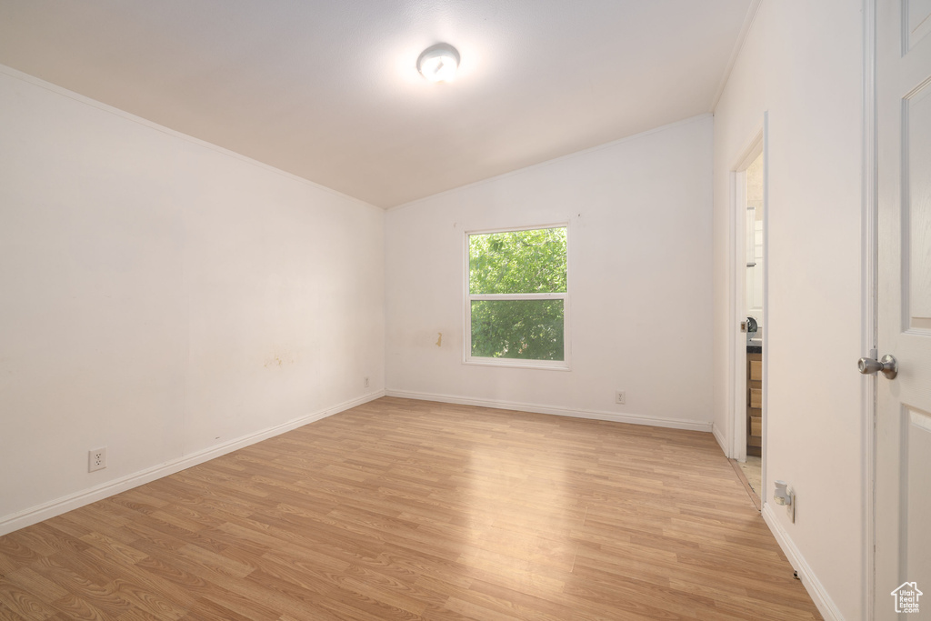 Empty room with light wood-style floors and baseboards