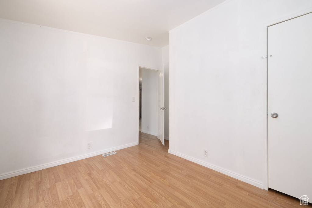 Empty room featuring light wood-type flooring and baseboards