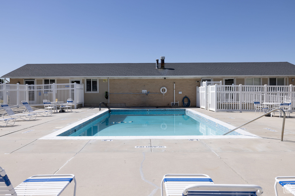 Community pool featuring a patio
