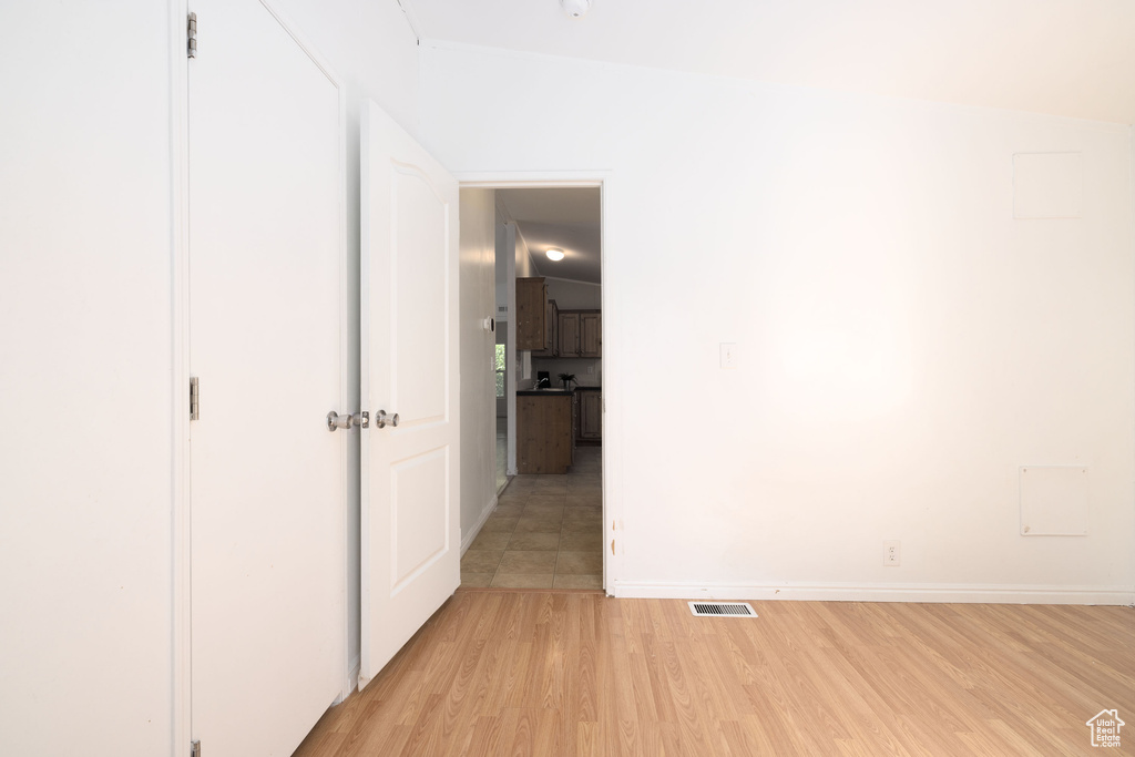 Unfurnished bedroom with light wood-style floors and baseboards