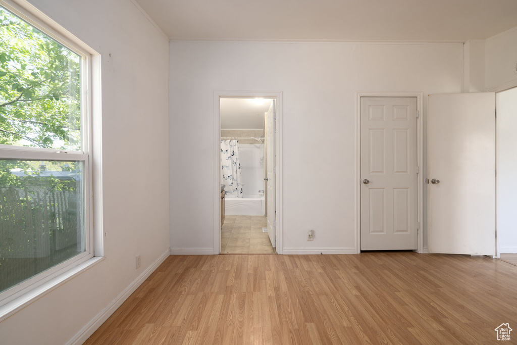 Unfurnished bedroom featuring light wood finished floors and baseboards