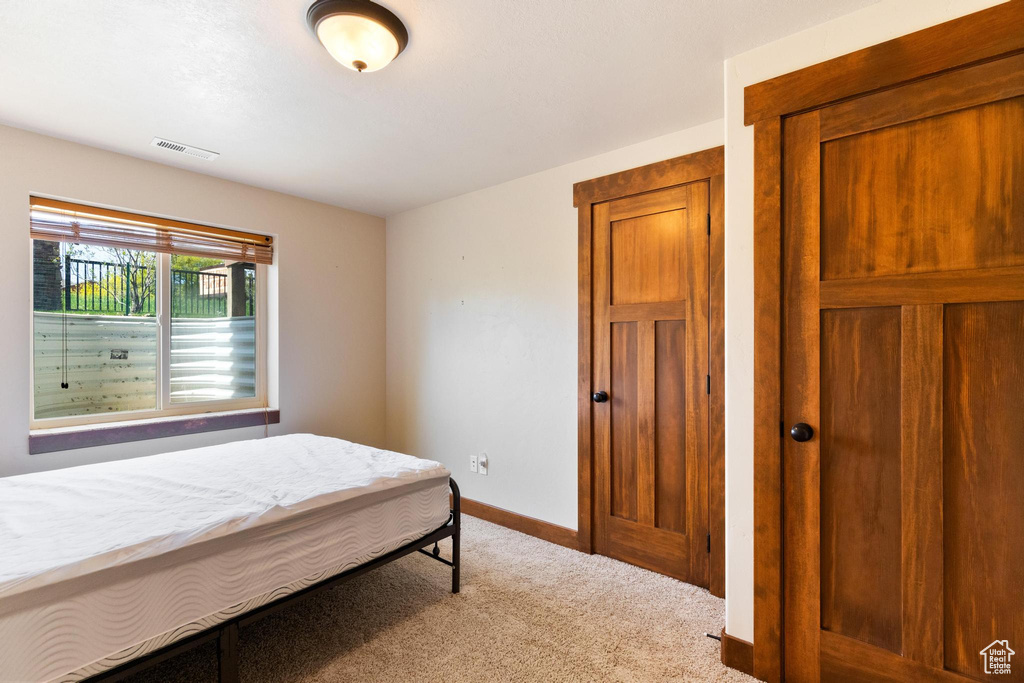 Bedroom featuring carpet flooring and baseboards