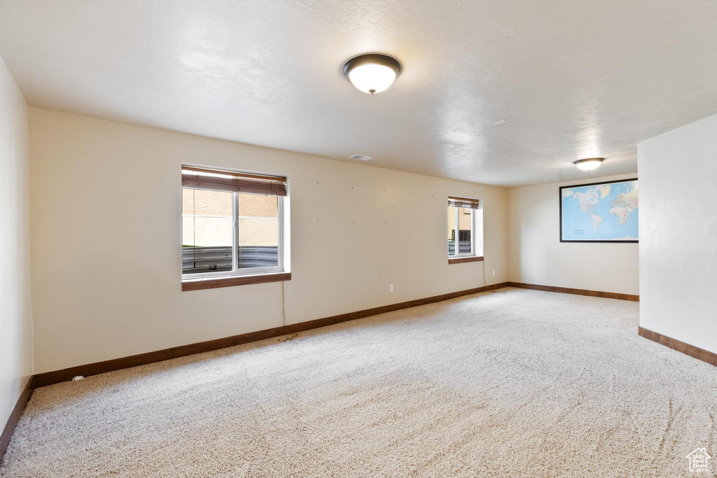 Carpeted empty room with baseboards