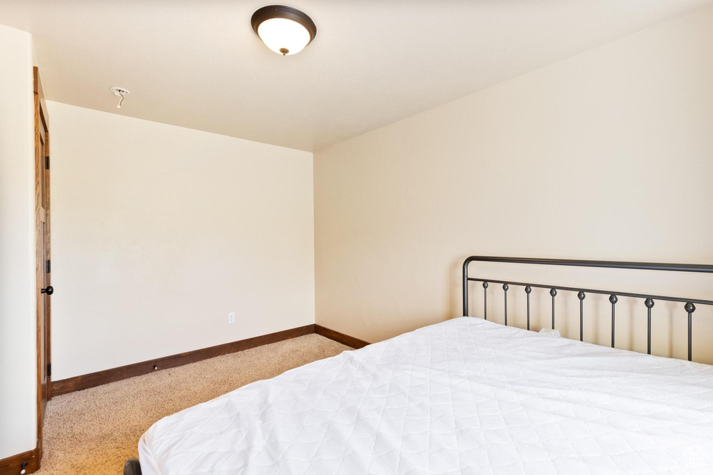 Carpeted bedroom with baseboards